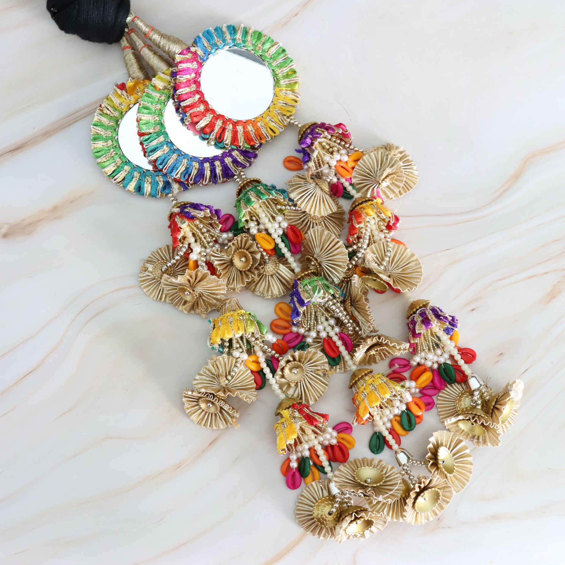 Colorful beaded parandi on a marble surface