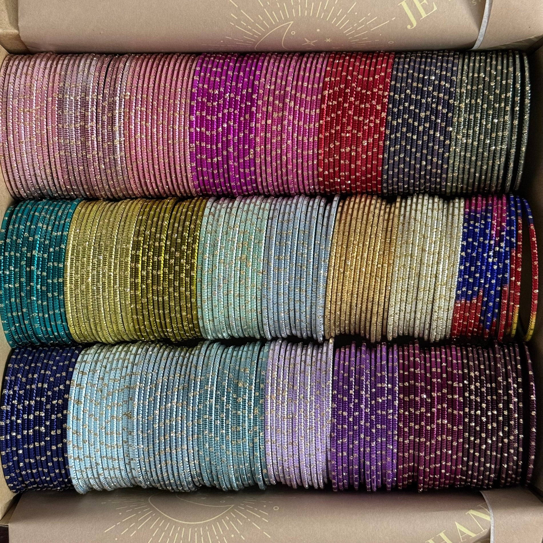 Stack of colorful bangles in a box