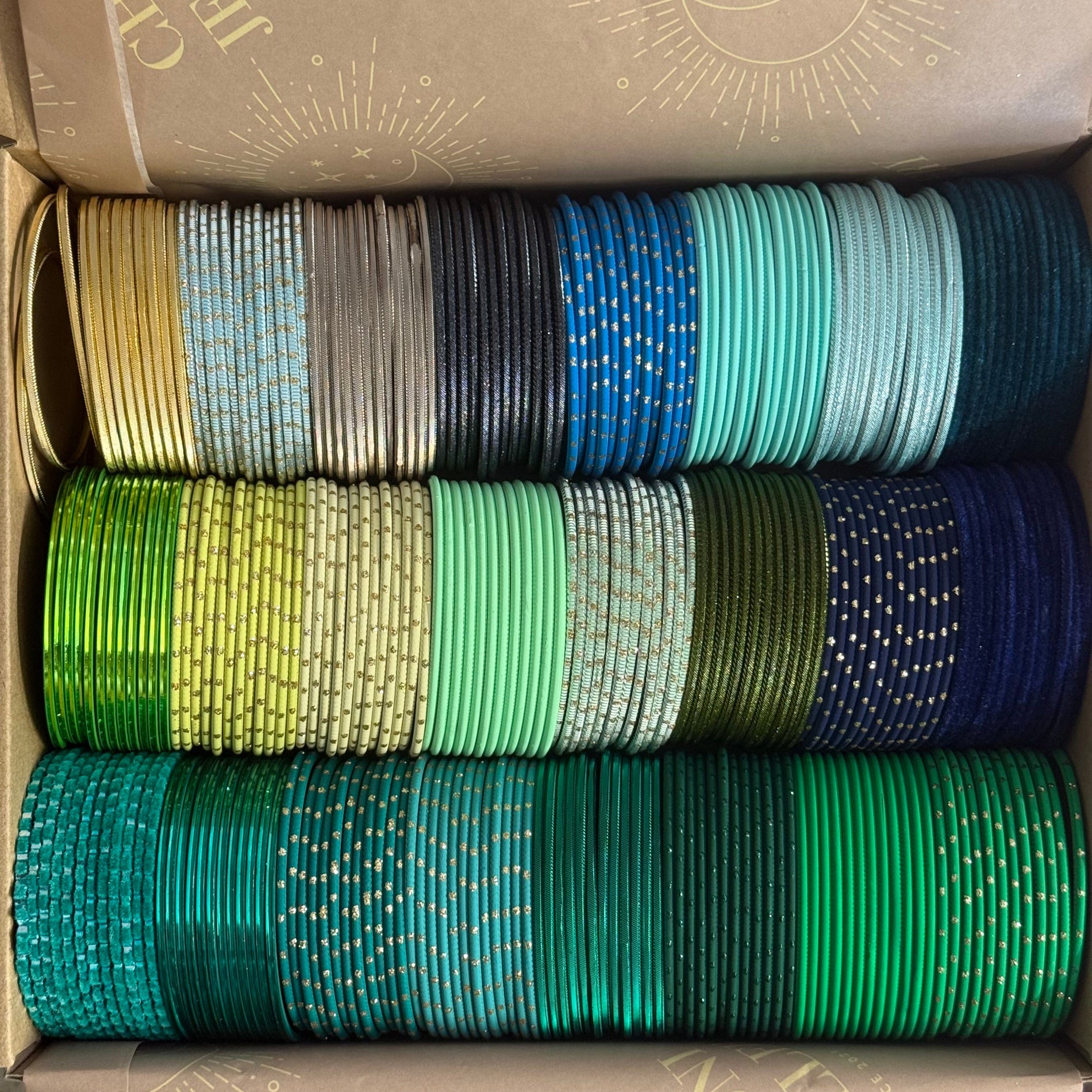 Box containing rolls of colorful bangles.