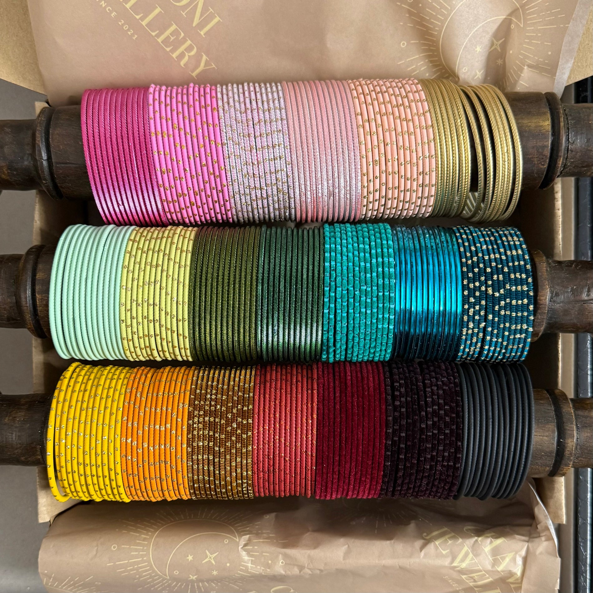 Colorful bangles stacked on a wooden holder