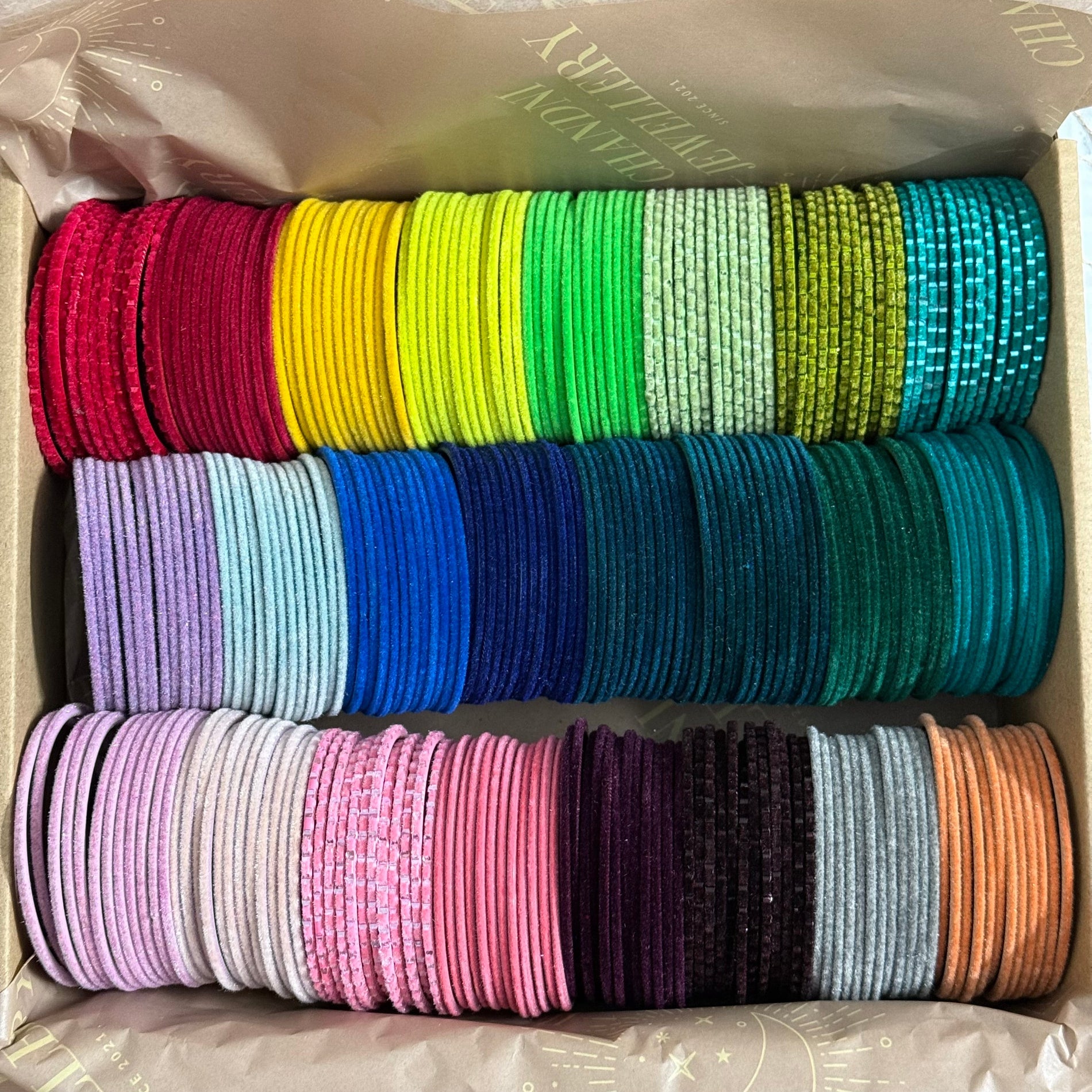 Box of colourful velvet bangles