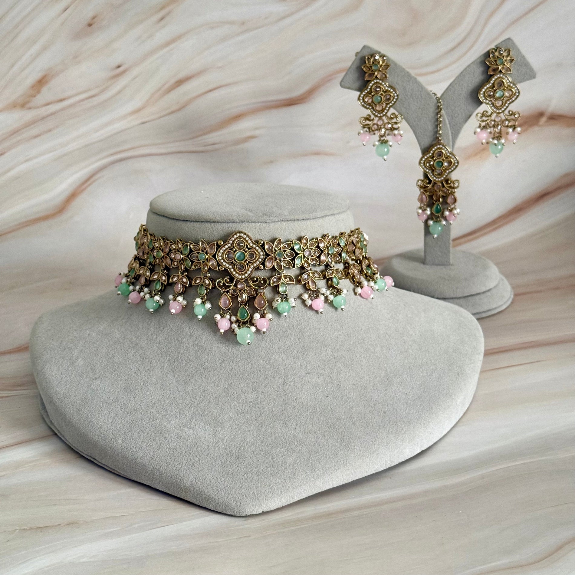 Jewelry set with a choker and earrings on a textured surface