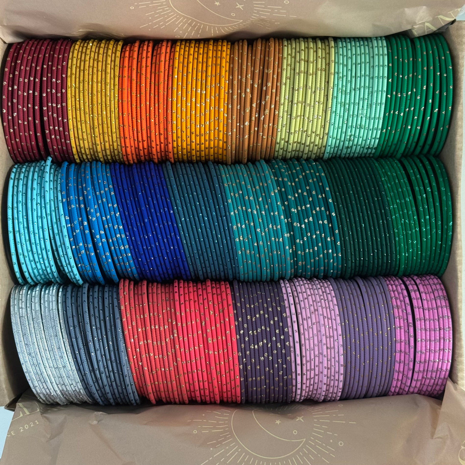 Stack of colorful bracelets in a box