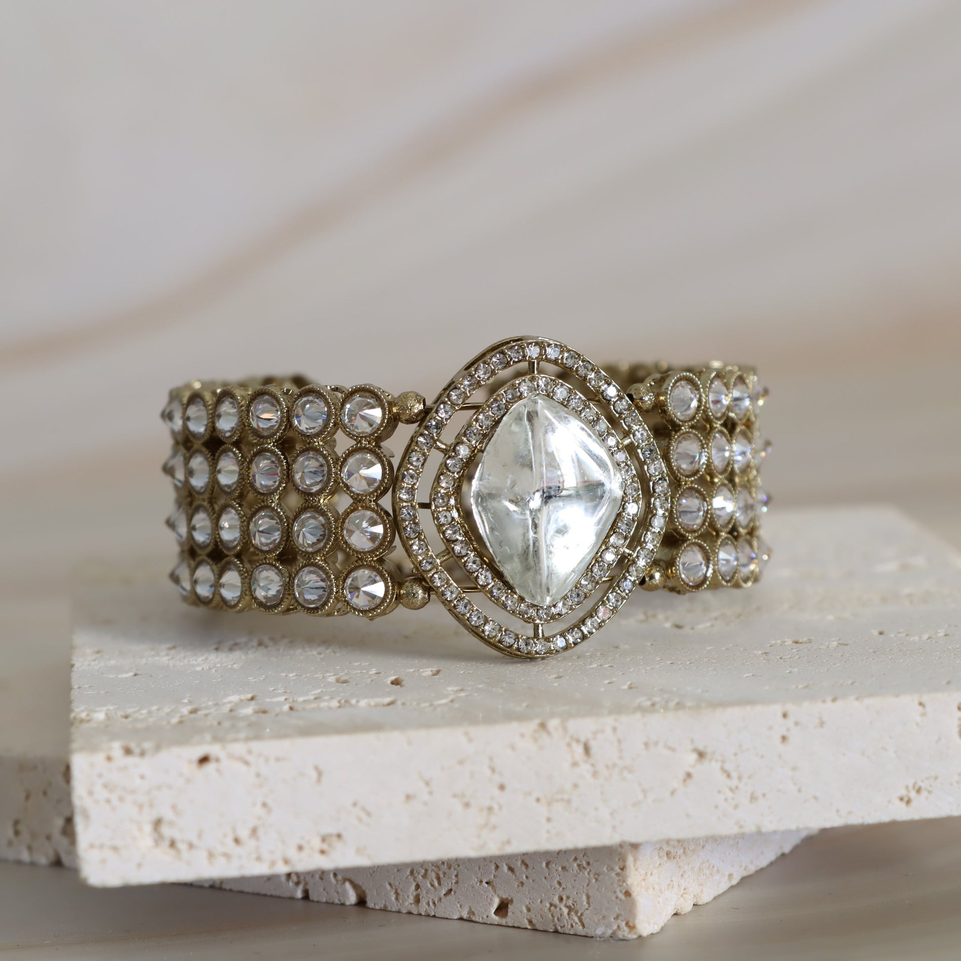 Decorative bracelet with gemstone on a stone surface