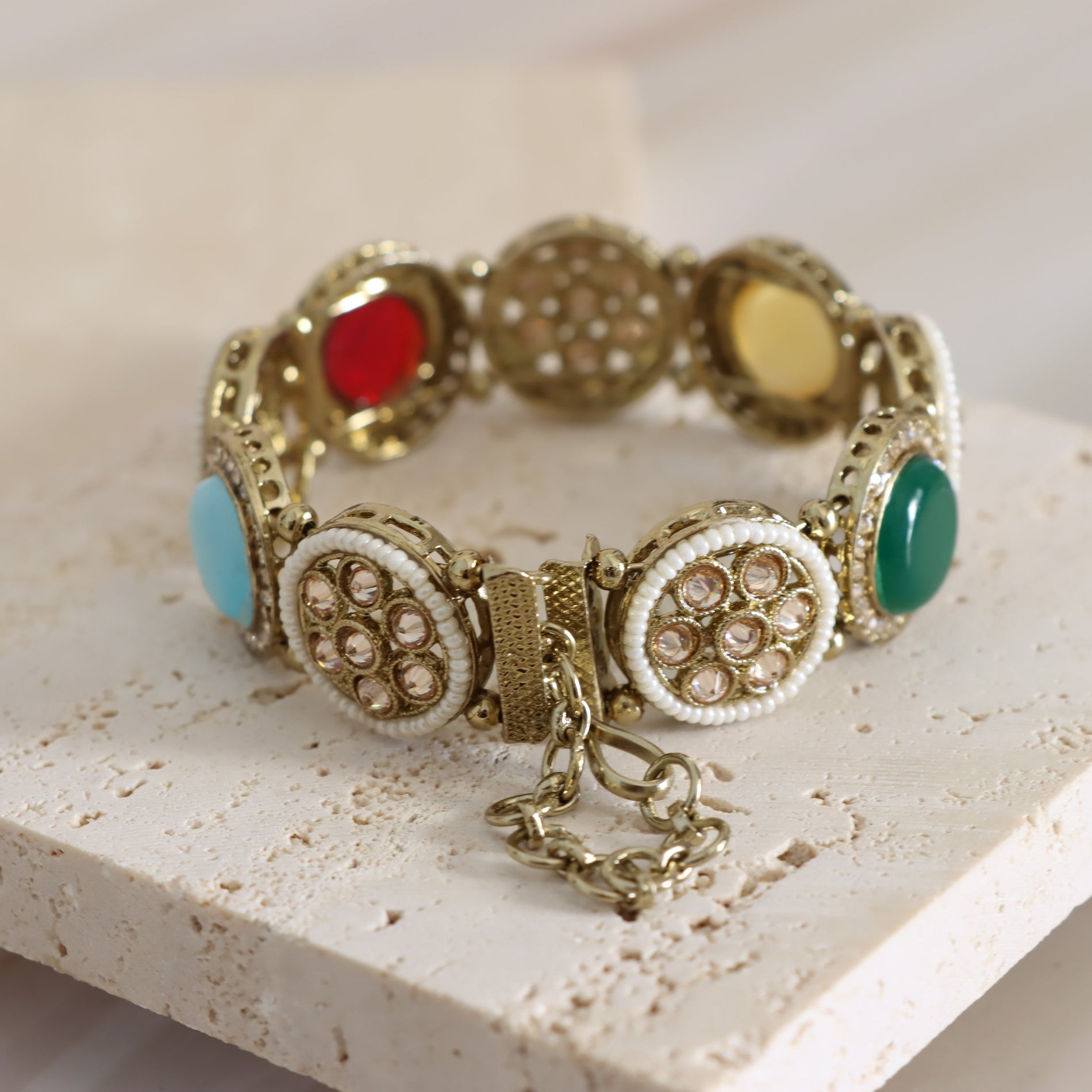 Decorative bracelet with colorful beads on a light stone surface