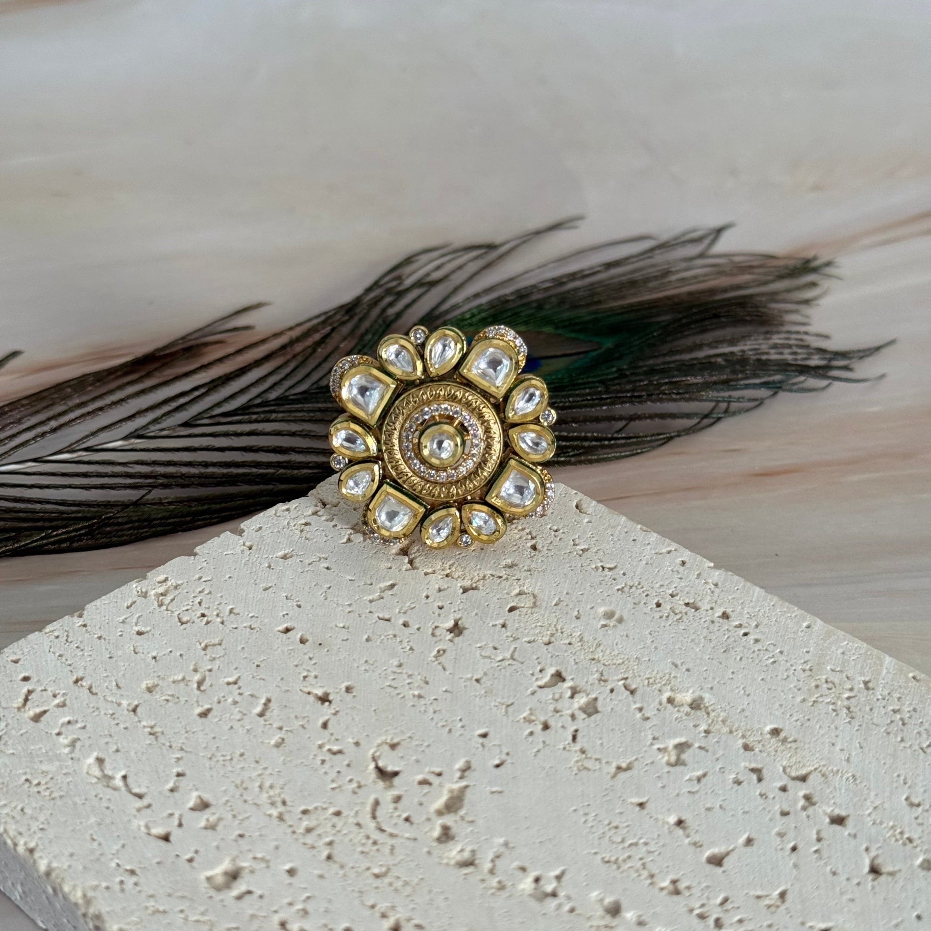Decorative ring with feathers on a textured surface