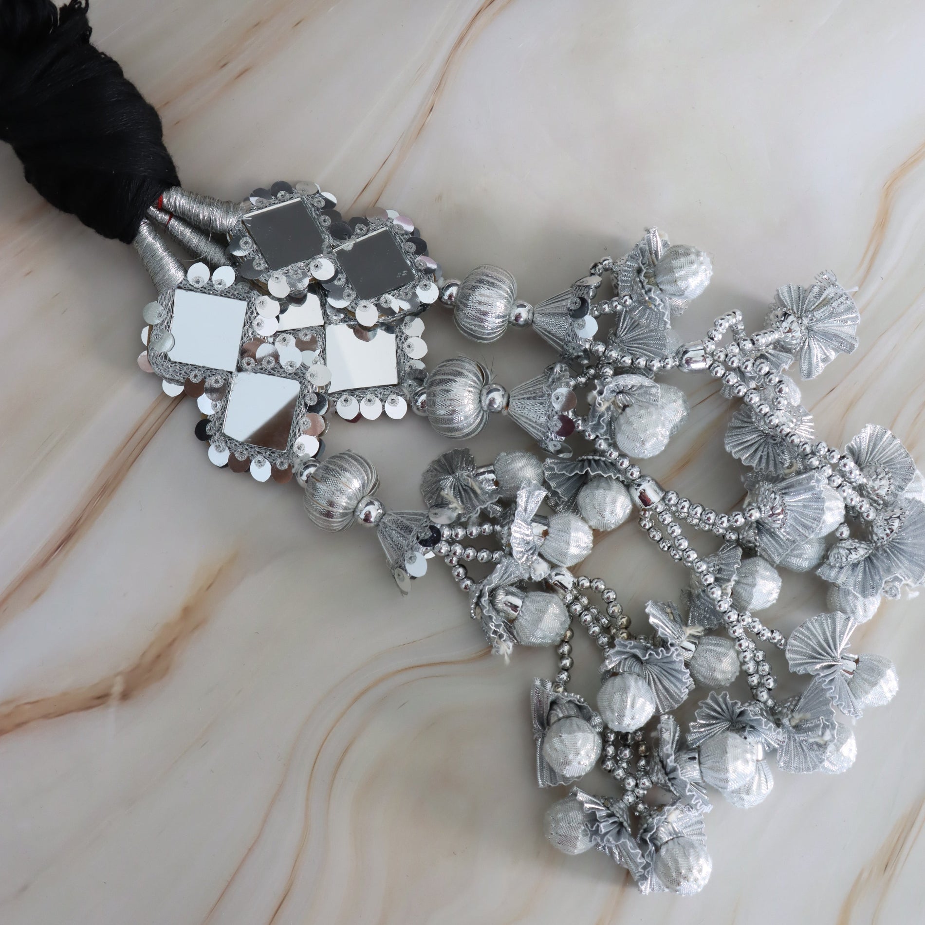 Decorative silver parandi on a marble surface