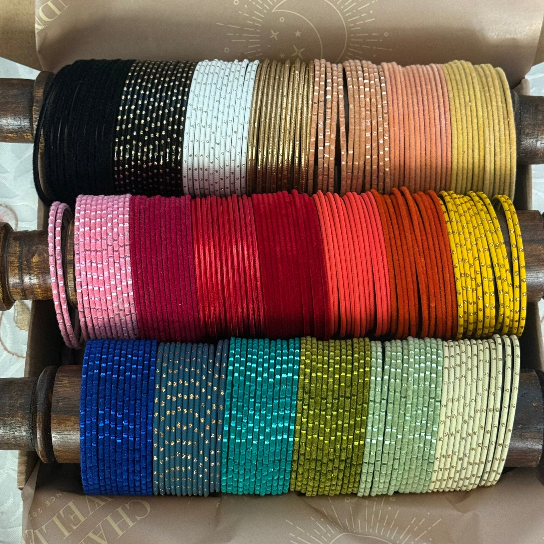 Stack of different colourful bangles in a box