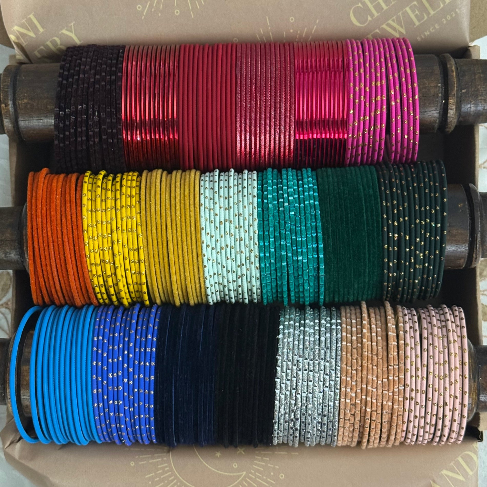 Stack of colourful bangles on a wooden stand 