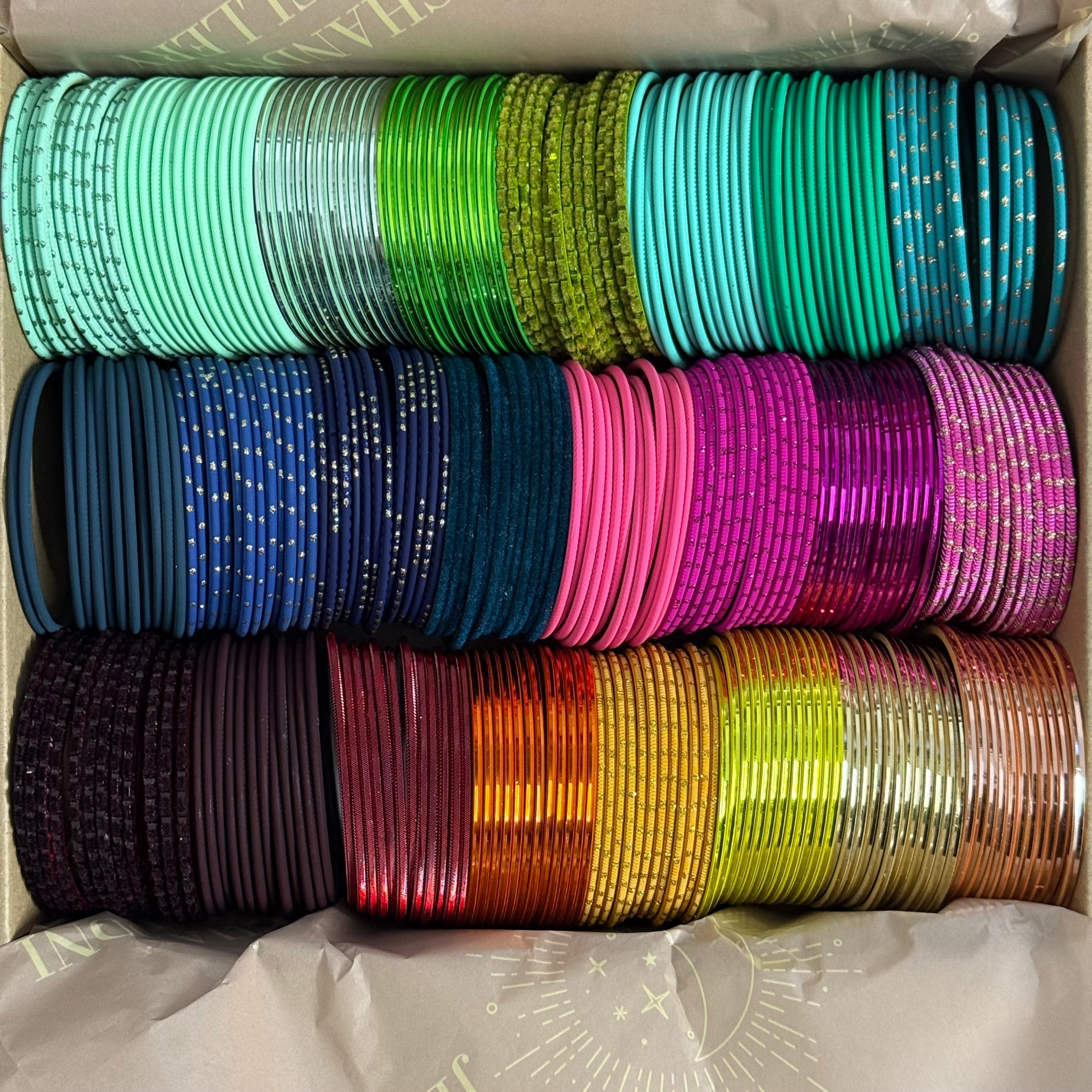Box containing colorful bangles stacked in rows.