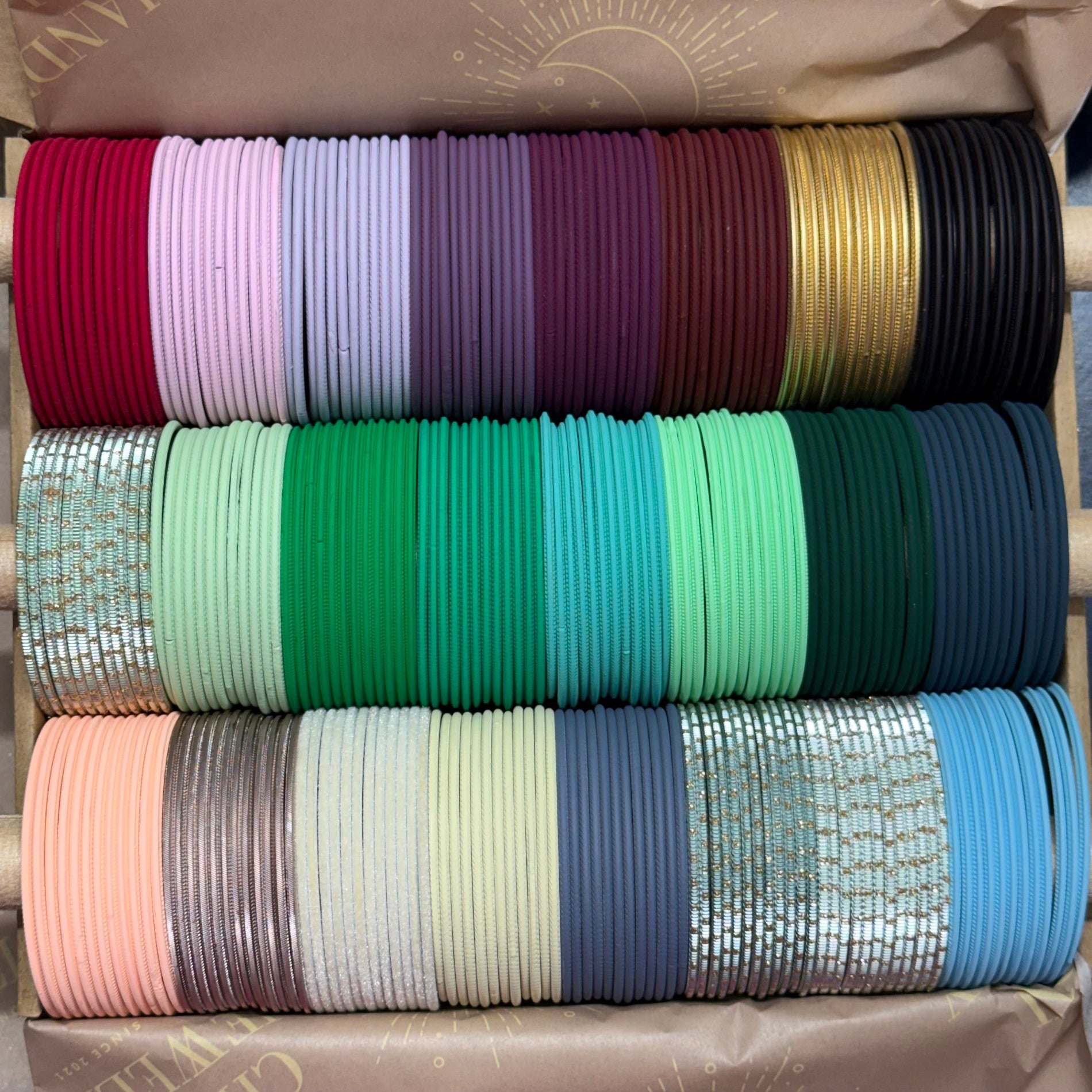 Stack of colorful ribbons in various patterns and colors on a neutral background