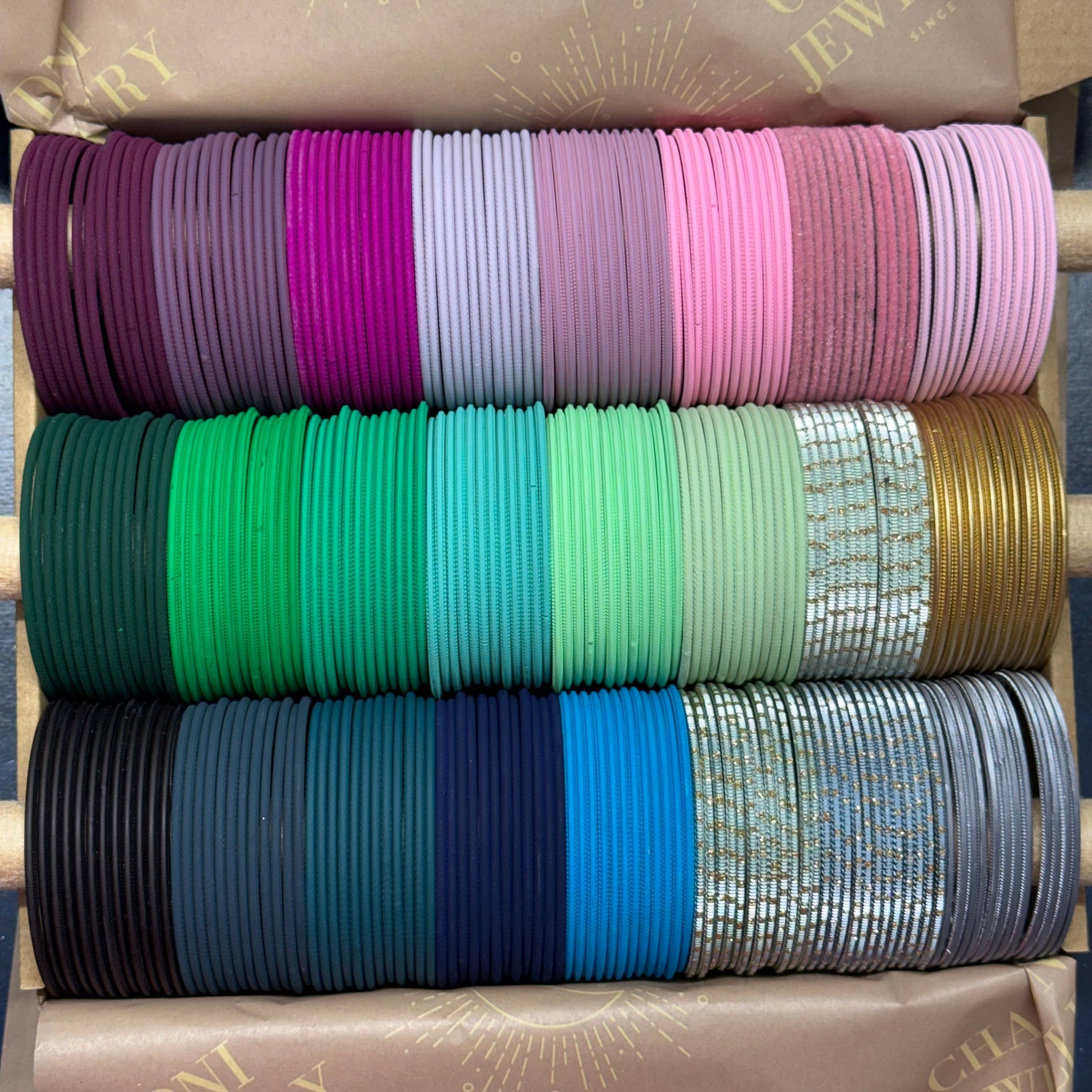 Stack of colorful bangles on a wooden rack