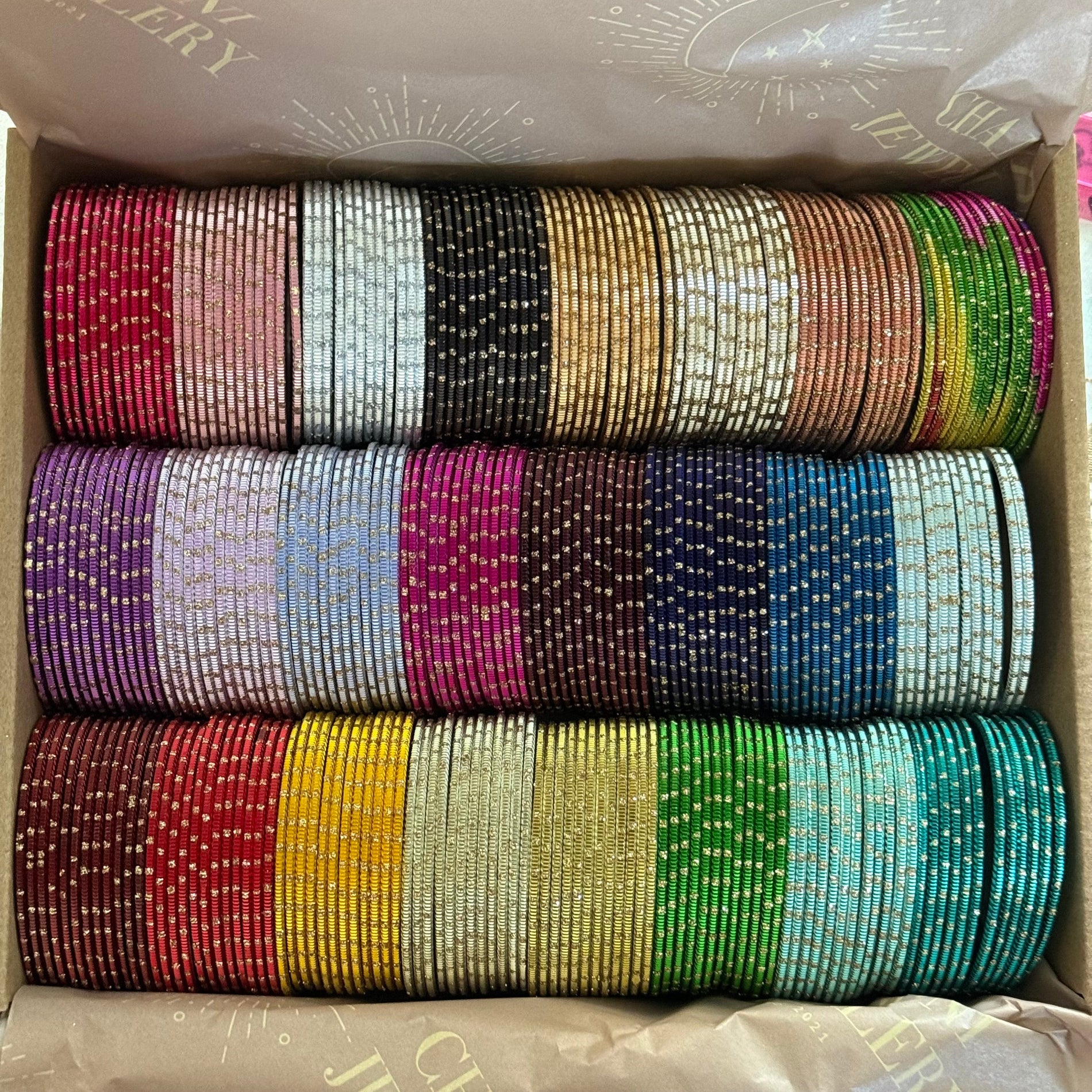 Box containing colorful bangles of various bangles and colors.