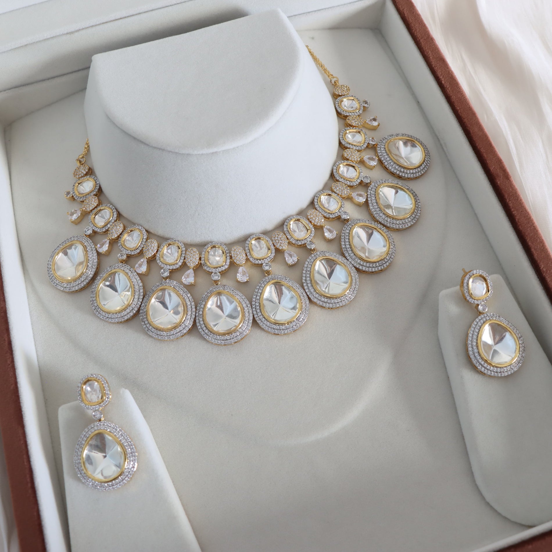 Gold and diamond necklace and earrings set in a jewelry box