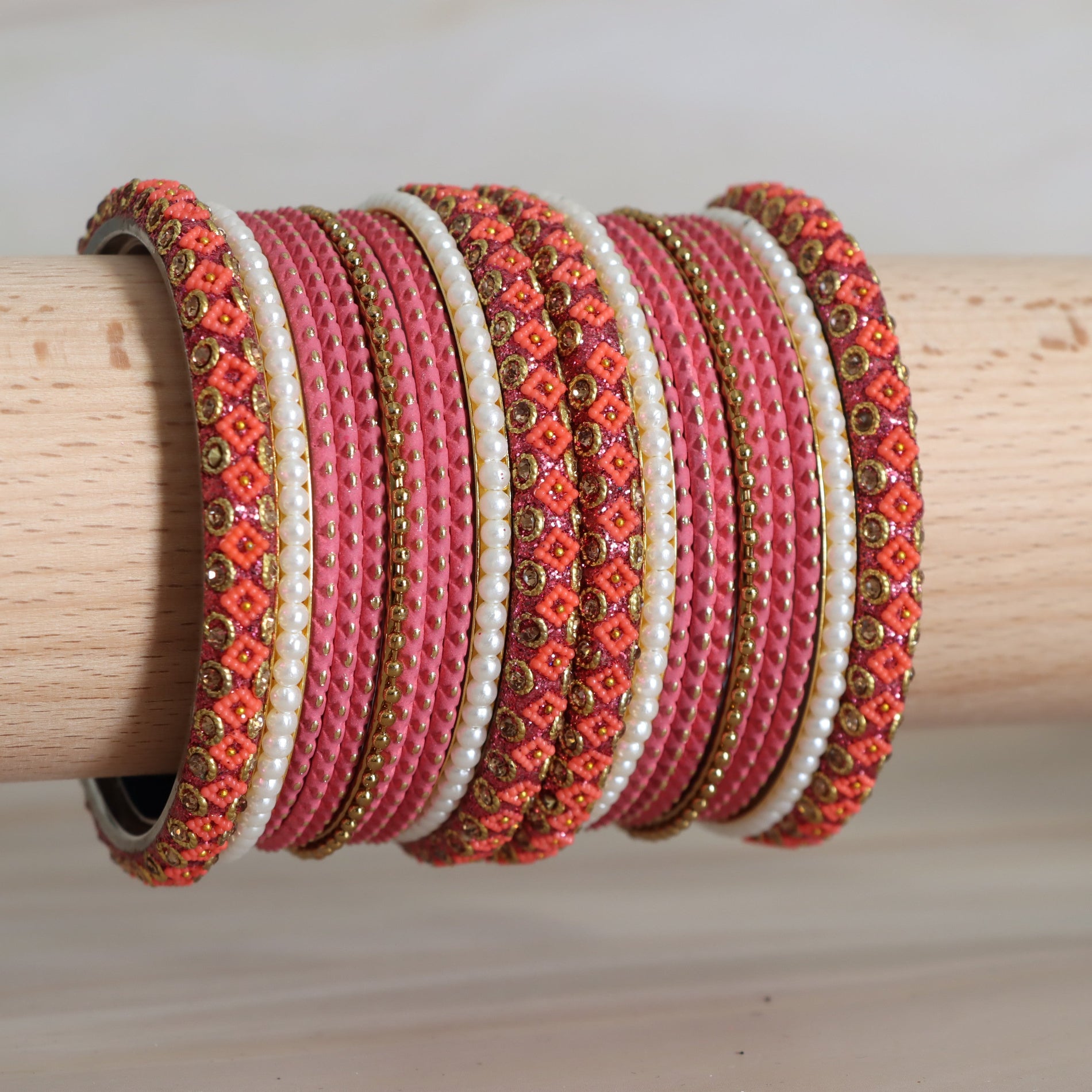 Set of colorful beaded bracelets on a wooden stick