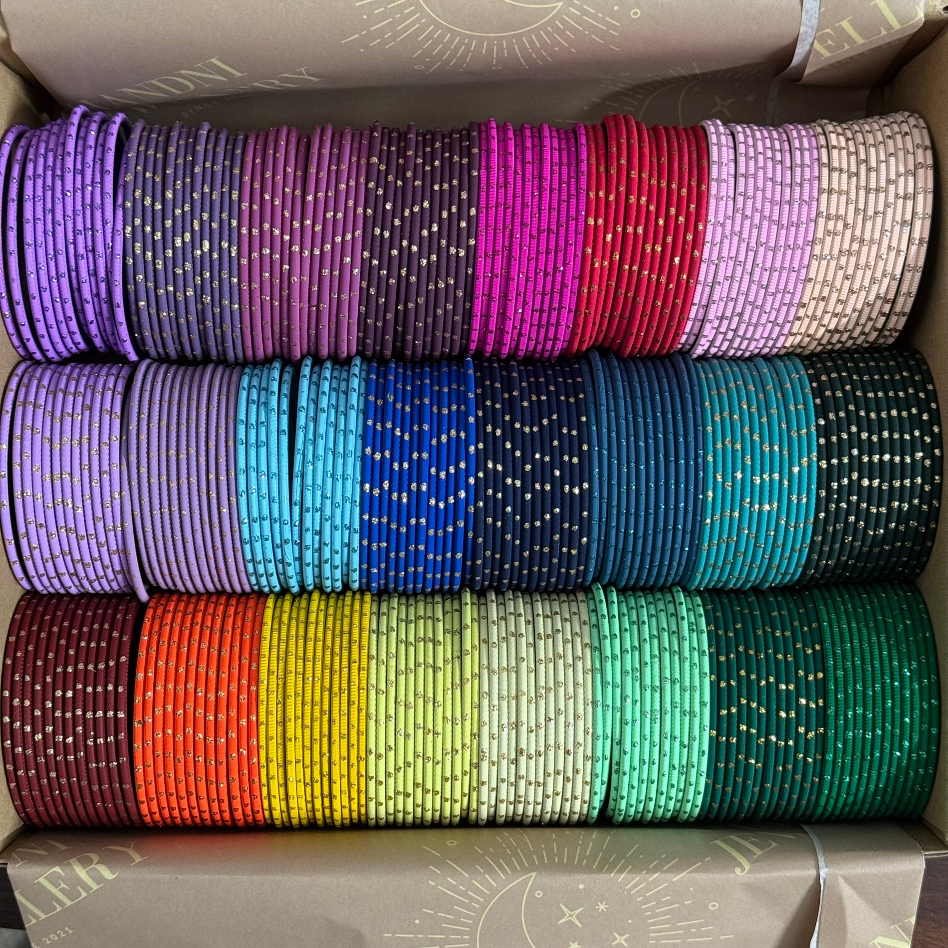 Stack of colorful bangles in a box
