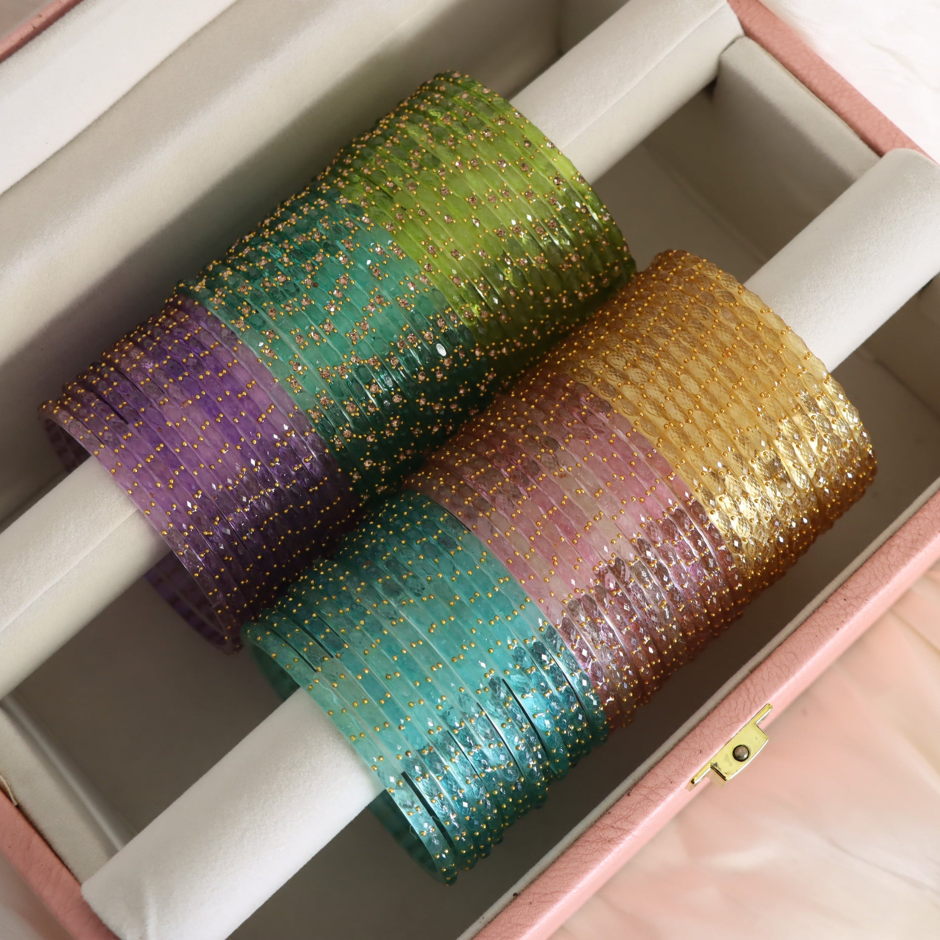 Pastel coloured glass bangles on bangle holders