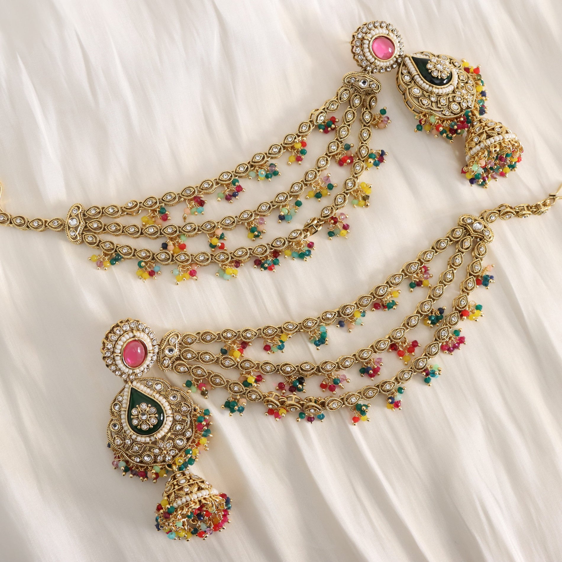 Decorative necklace with colorful beads on a white fabric background