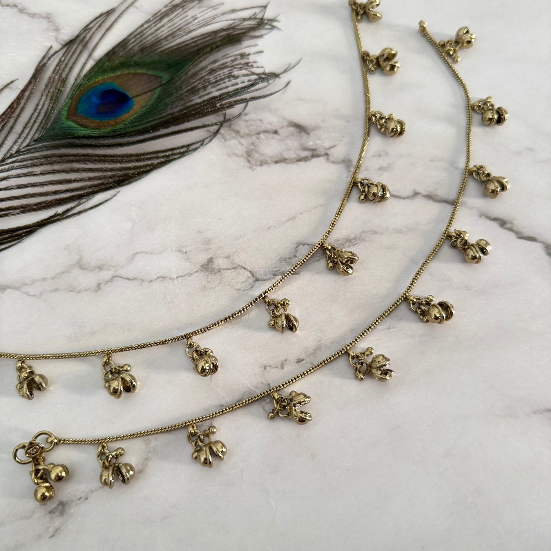 Golden ankets with open bells on a marble surface
