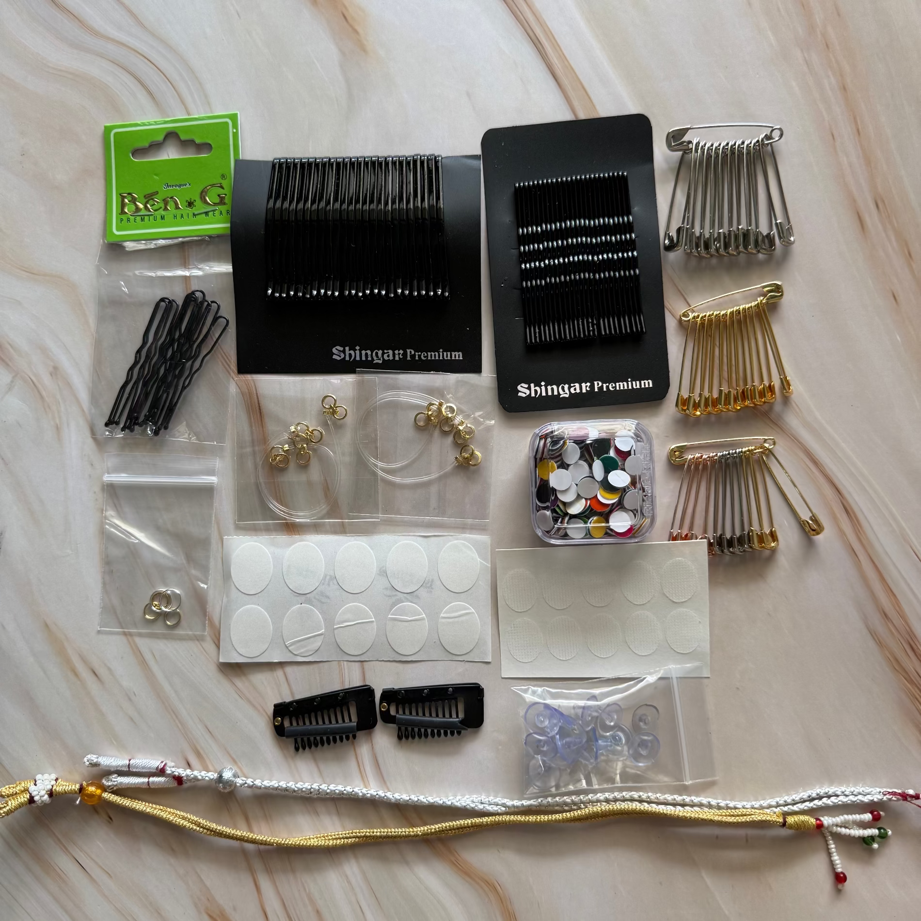 Collection of hair accessories and tools on a marble surface